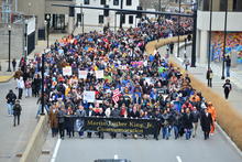 A large crowd of people participating in a Martin Luther King Jr. commemorative march in Lexington, Kentucky.