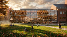 A modern glass-and-steel building overlooks a grassy lawn where several people are gathered.