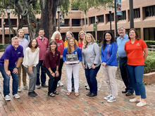 UK professor of STEM Education Lisa Amick, Ph.D., (center, holding laptop) with members of the SEC + Mathematics Community