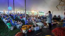 a crowd of people are seated underneath a tent at UK's Research and Education Center in Princeton, Kentucky