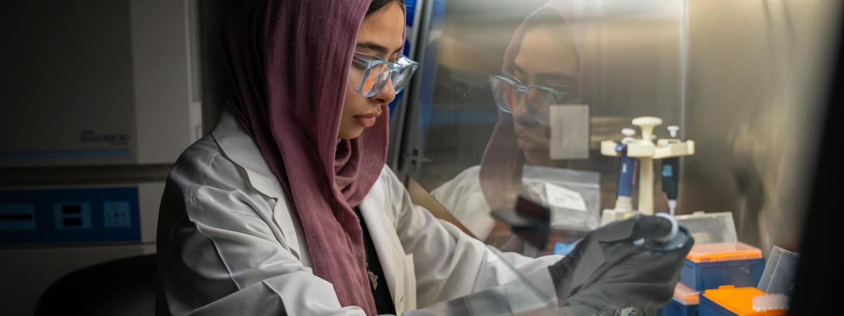 UK student at the time Elaf Ghoneim uses lab equipment under a chemical hood