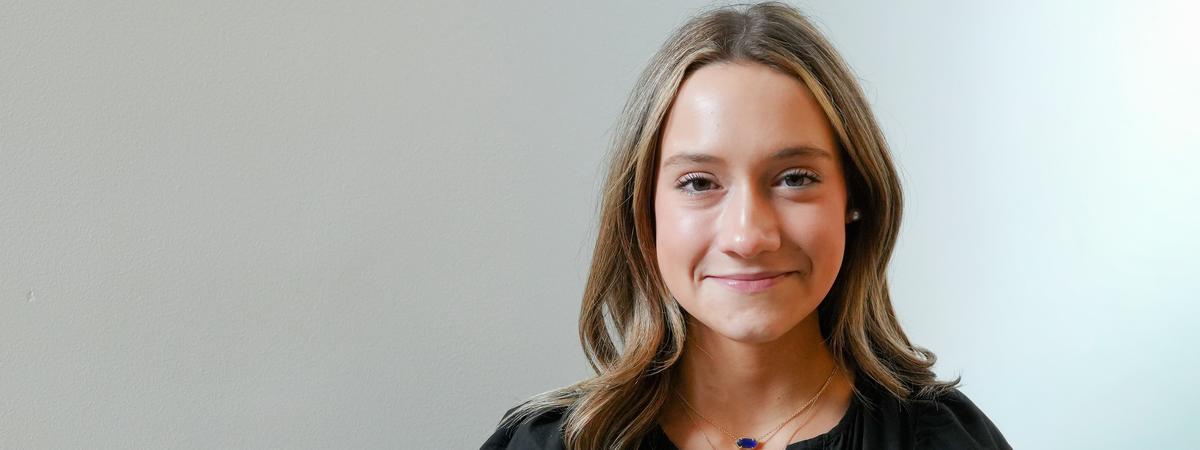 University of Kentucky public health student Hollie Hagan wearing a black dress against a light background.