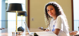 This is a photo of a student in the William T. Young Library. 