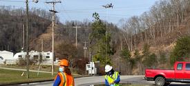 Kentucky Homeplace community health workers Chyna Smith, left, and Carole Frazier retrieve a package delivery from a drone.