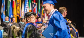 photo of Dean Cox and student at commencement ceremony