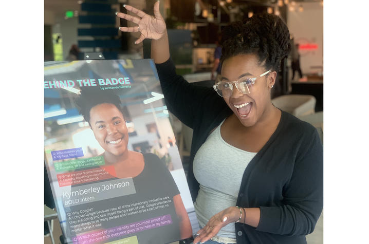 Kymberley Johnson poses in front of her poster at Google
