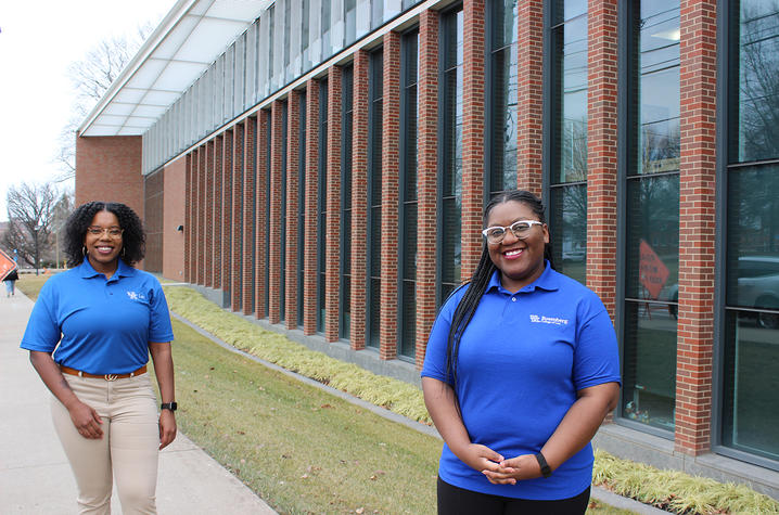 Shantale Davis and Ashlei McPherson, both first-year law students, pictures in front of the J. David Rosenberg College of Law