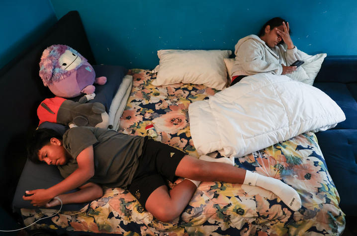 Adan Macias and his mother, Rosario Macias, rest in their bed on Sunday, June 1, 2025, in their home in Daly City, California. On Sundays, the two spend as much time together as possible, even if it's just resting in bed. Photo by Abbey Cutrer.