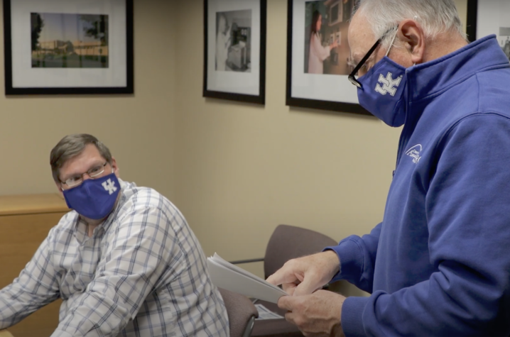 Wayne Sanderson in background of classroom with student