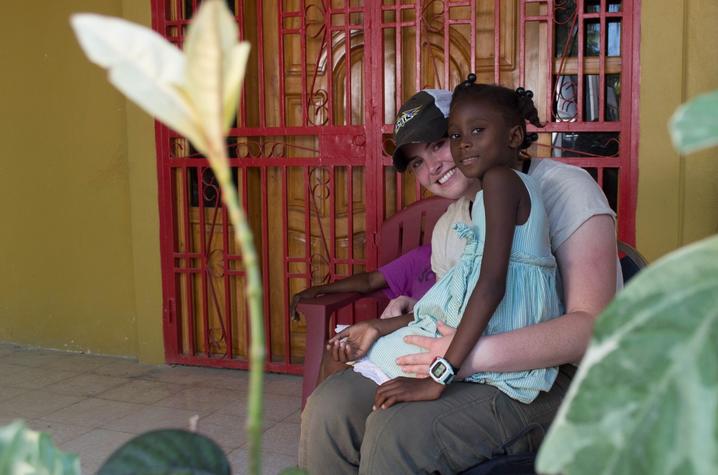 photo of UK student and child at Haiti orphanage
