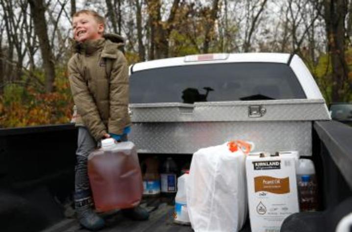 photo of boy with container of grease