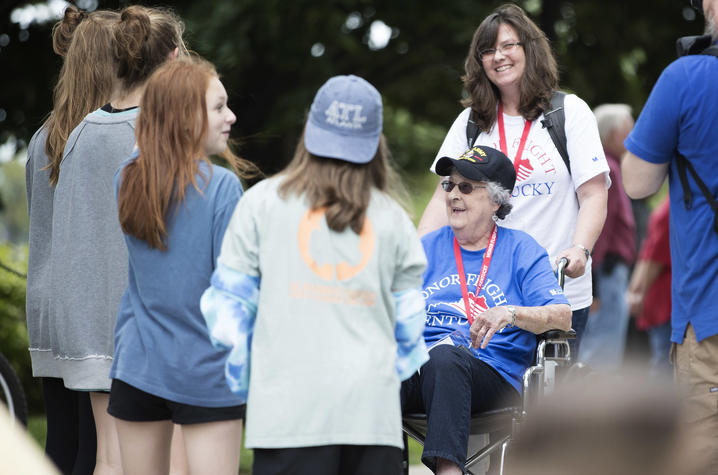 Photo of a veteran and her daughter with a group of girls