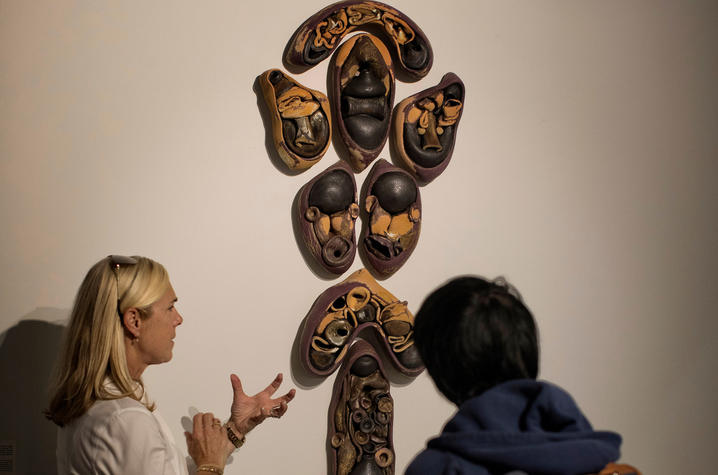 photo of 2 people with Hunter Stamps sculpture - “Faculty Series: Vol. I.” Mark Cornelison | UK Photo.