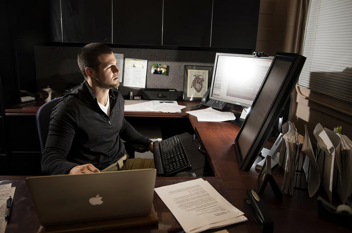 Alex Elswick sitting at his computer working