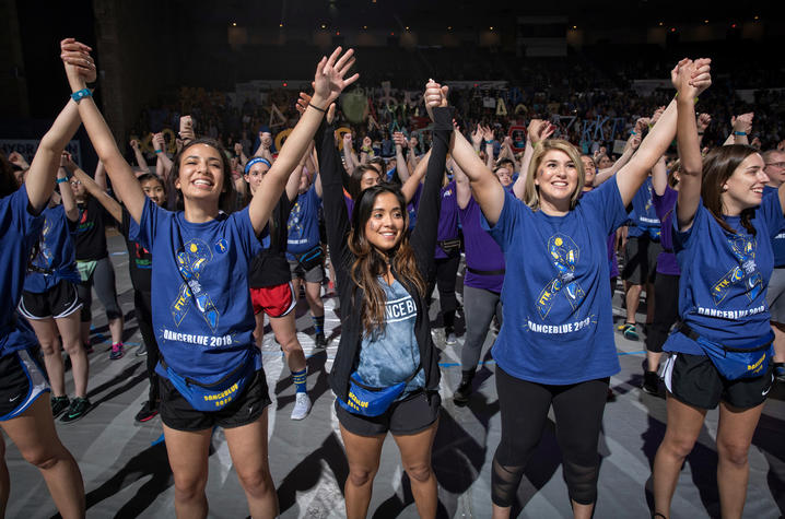 Students hold hands during DanceBlue 2019