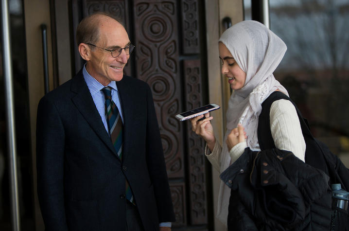 photo of Capilouto and Hadeel Abdallah holding her cellphone