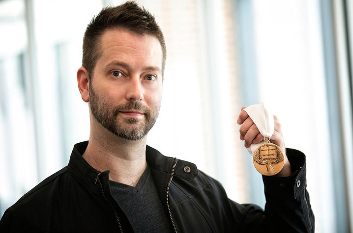 photo of Lennon Michalski holding medal