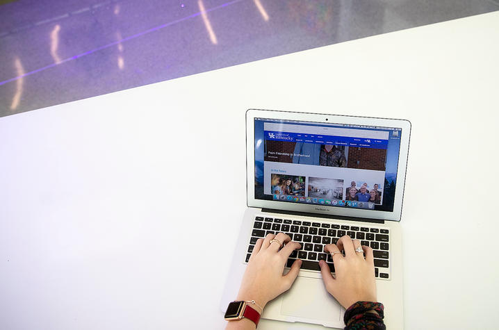 Hands at a computer typing