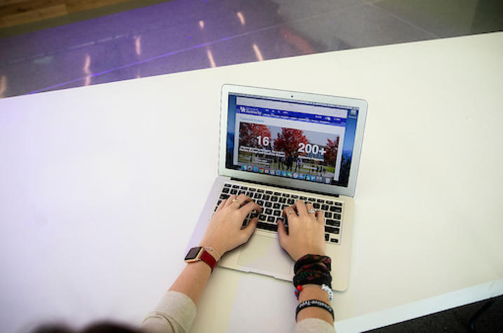 Student typing on a computer. 