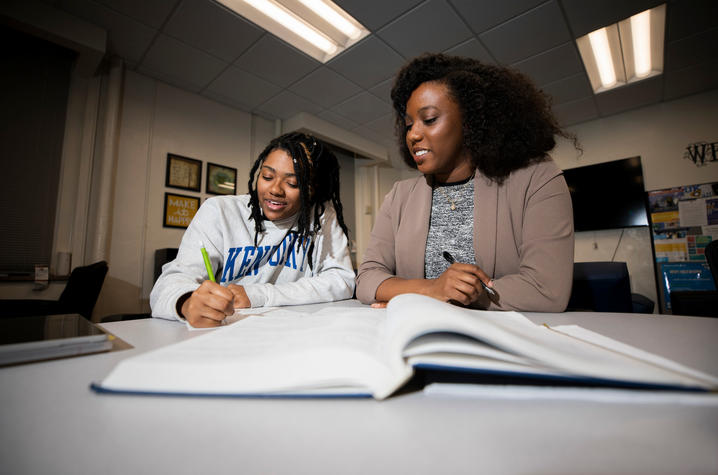 Student and tutor working on homework. 