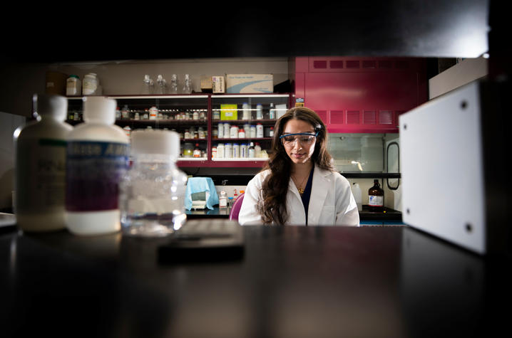 Amina Nouri conducts experiments in the lab | Photo by Pete Comparoni