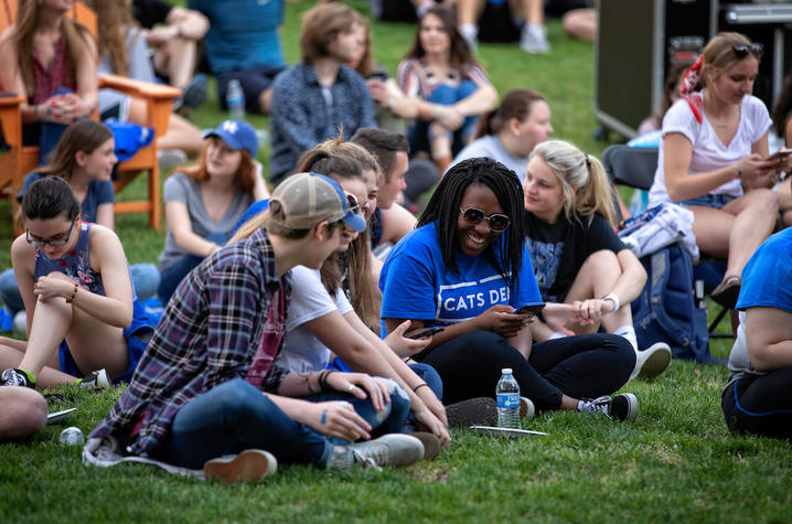 Photo of students sitting together on lawn