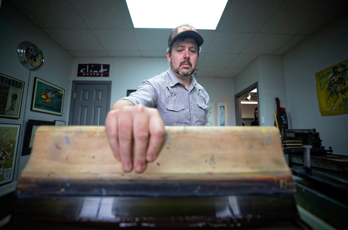 Brian Turner applying ink to print