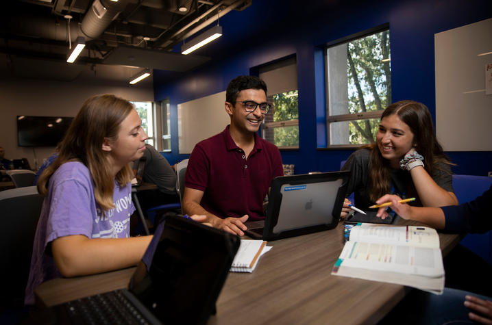 Photo of students sitting at a table studying together