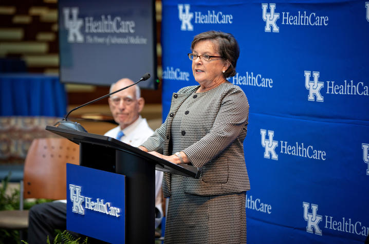 Dean Nancy Cox speaks at podium