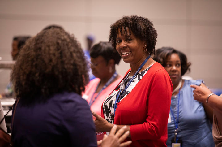 Photo of two women speaking to each other