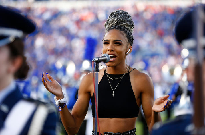 Chloe Abbott singing at UK Football game