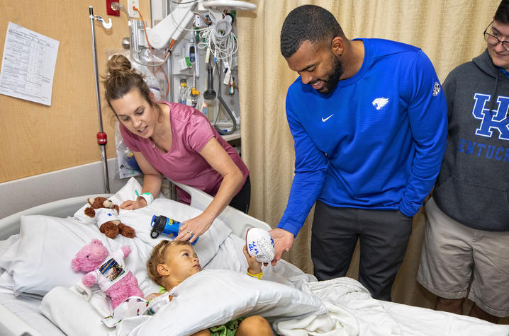 Courtney Love hands football to young patient