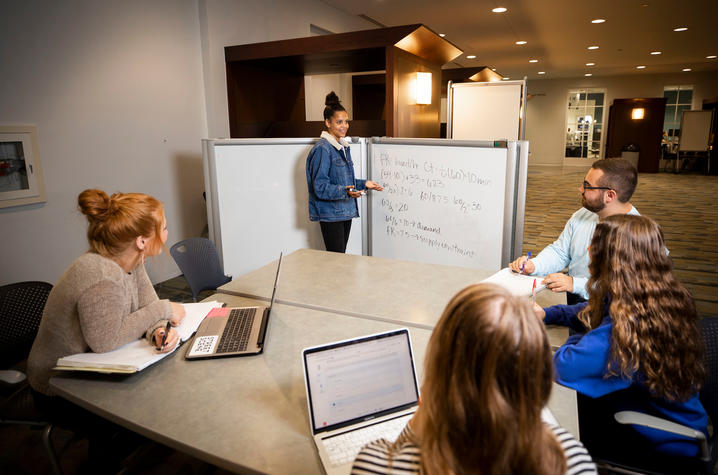 This is a photo of students studying inside of the William T. Young Library. 