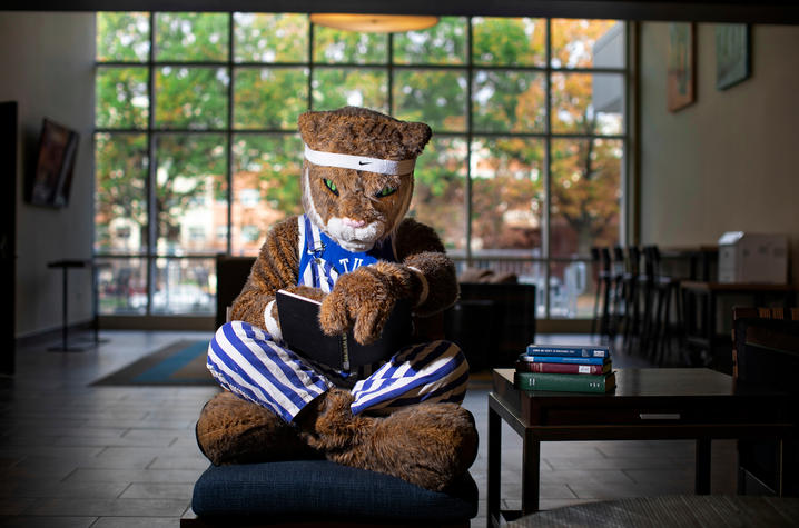 UK Wildcat reading book inside residence hall