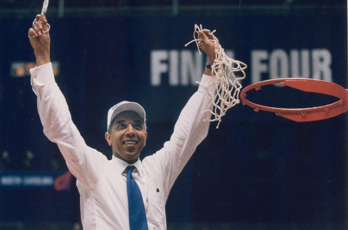  Orlando “Tubby” Smith cutting basketball net in white shirt and white hat