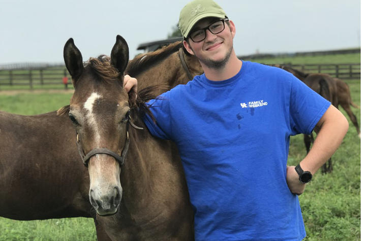 Zachary Chaney pictured with horse on farm