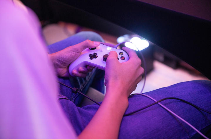 photo of young man's hands playing an egame.