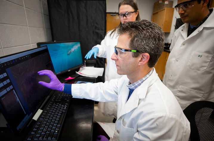 David McNear at computer in lab