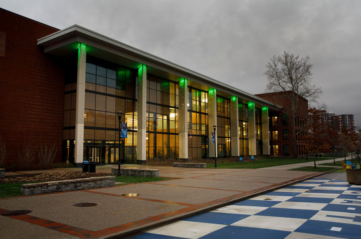 photo of Jacobs Science Building lit in green