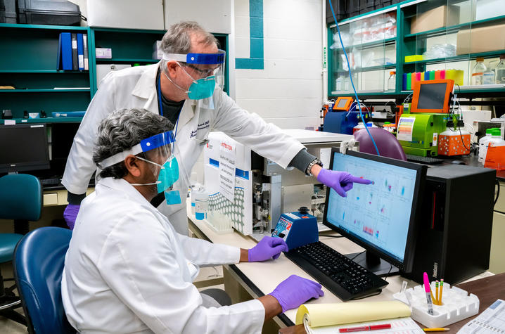 UK researchers Jerry Woodward and Siva Gandhapudi analyzing T cells from mice vaccinated with PDS Biotech’s COVID-19 vaccine candidate, PDS0203. Photo by Ben Corwin, Research Communications.