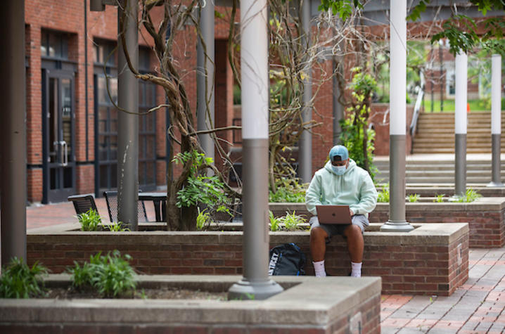 Photo of student studying on campus