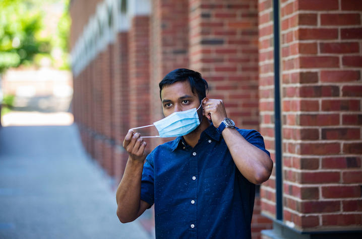 Photo of student putting on mask