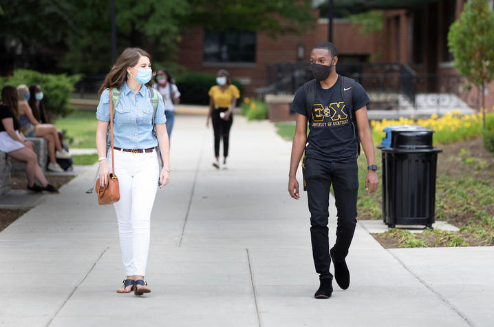 Photo of students wearing masks walking through campus