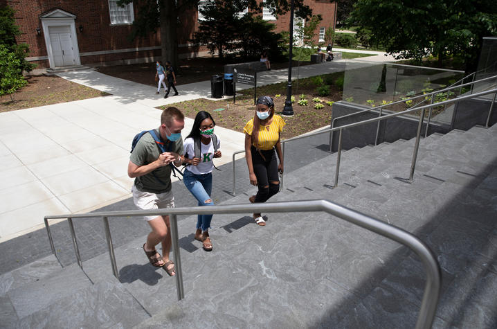 photo of students walking up the outside steps of the Rosenberg College of Law.