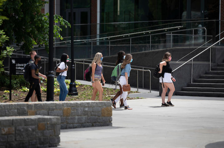 Photo of students wearing masks walking through campus