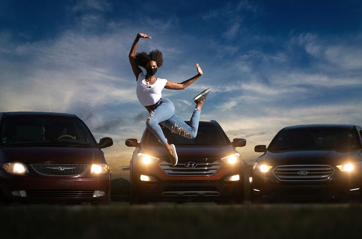 photo of Connor Perry dancing in front of cars illuminated by cars for "Once Vacant"