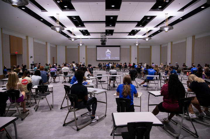 photo of students in large ballroom, physically distanced