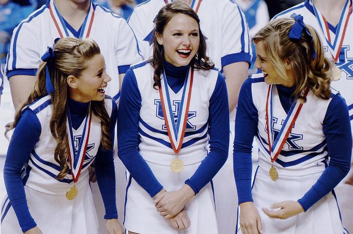 photo of three of UK's cheerleaders with medals at Rupp from 2010 Kentuckian