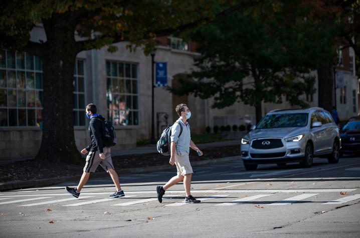 pedestrians walking a cross walk. 