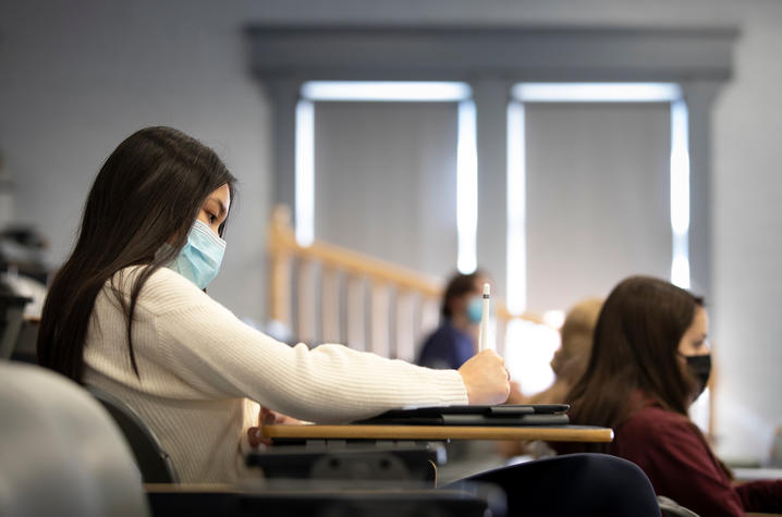 Photo of student studying in class with mask on
